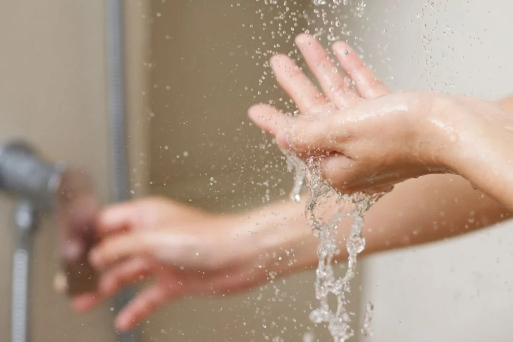 checking water temperature in shower